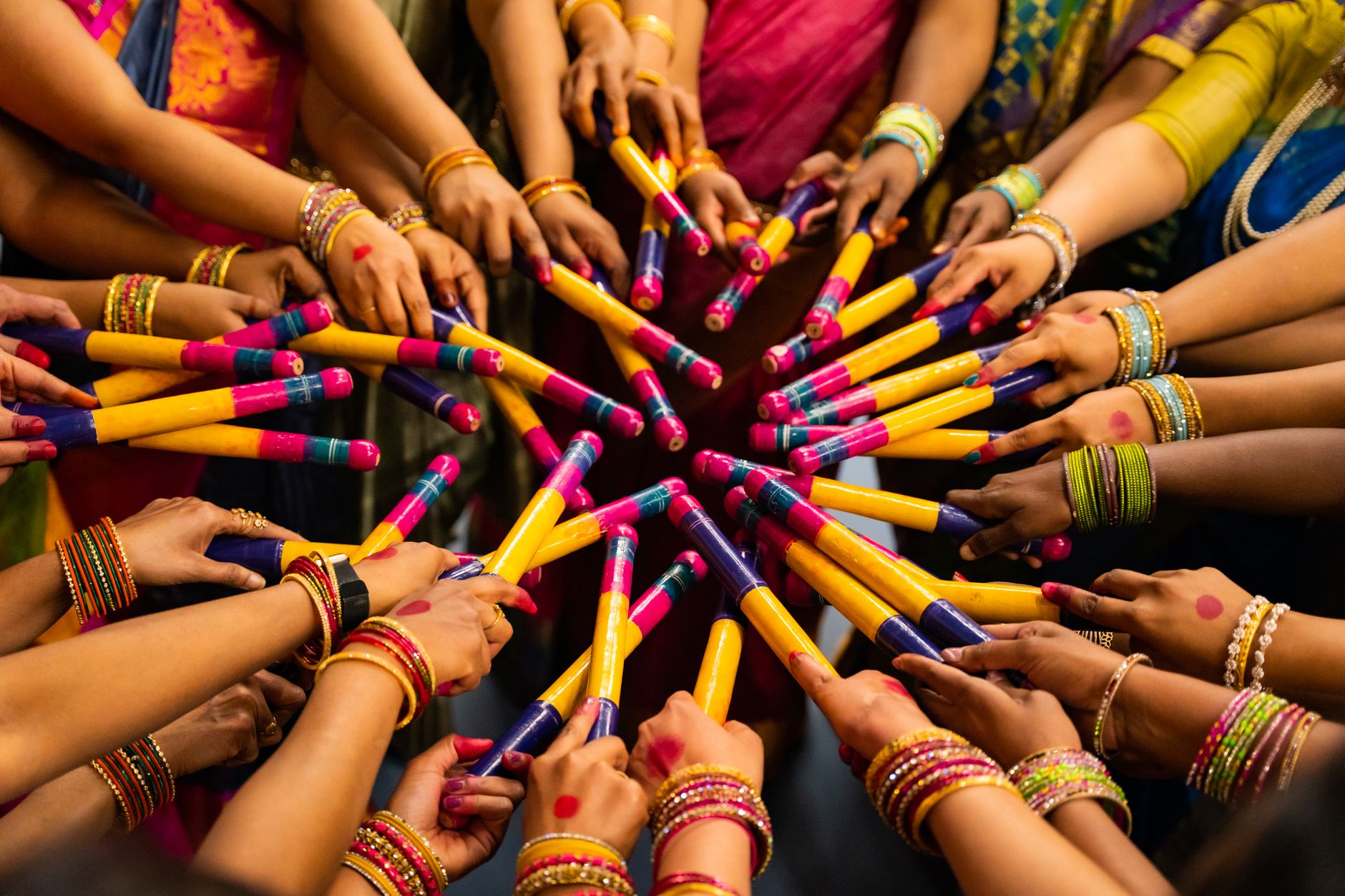 people with dandiya sticks celebrating navratri festival