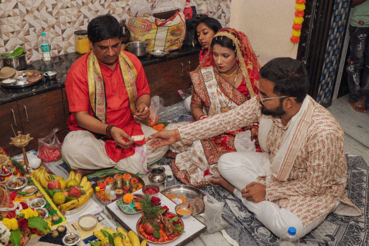 a man and woman are sitting on the floor with food