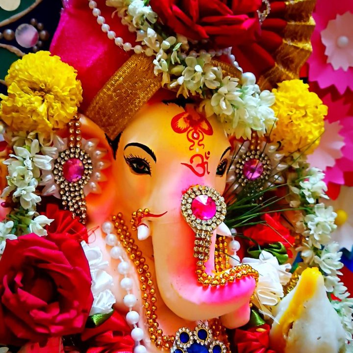 colorful ganesh idol adorned with flowers and jewelry