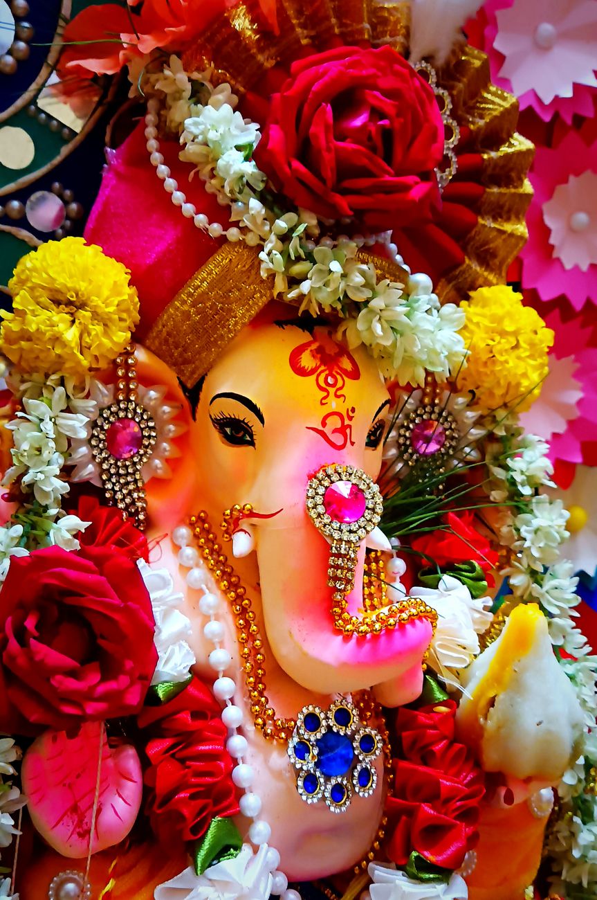 colorful ganesh idol adorned with flowers and jewelry