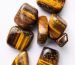 polished tiger s eye stones on white background