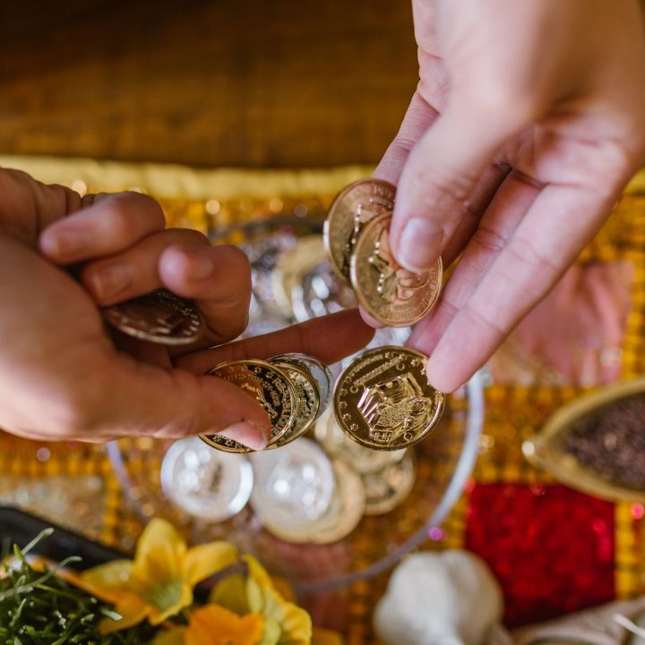 person holding golden coins