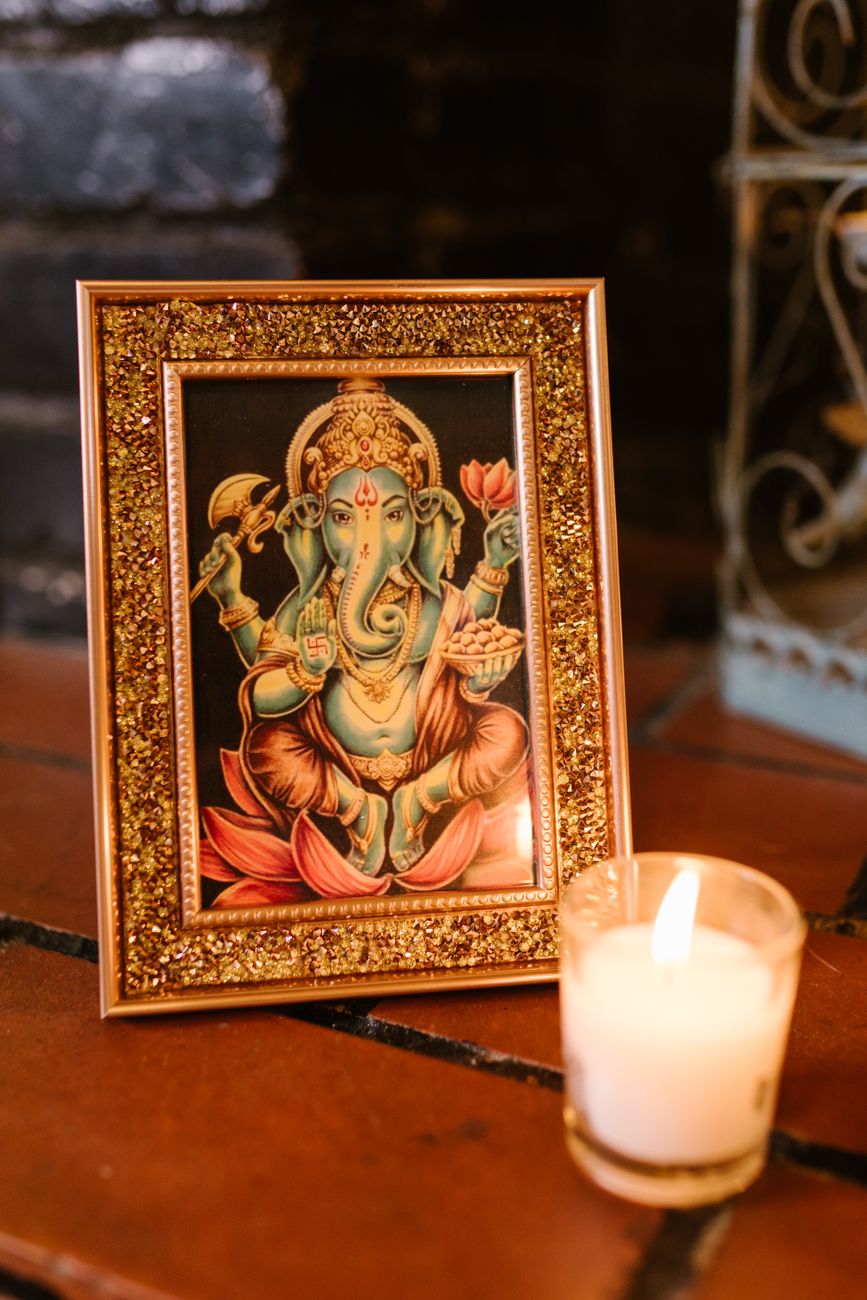 a gold framed image of ganesha