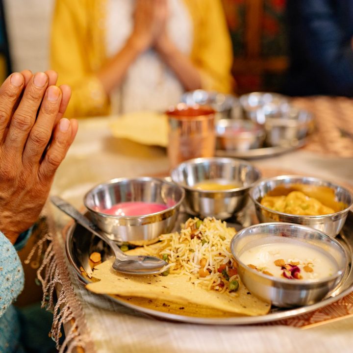 a person praying in front of the foods on the table