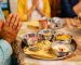 a person praying in front of the foods on the table