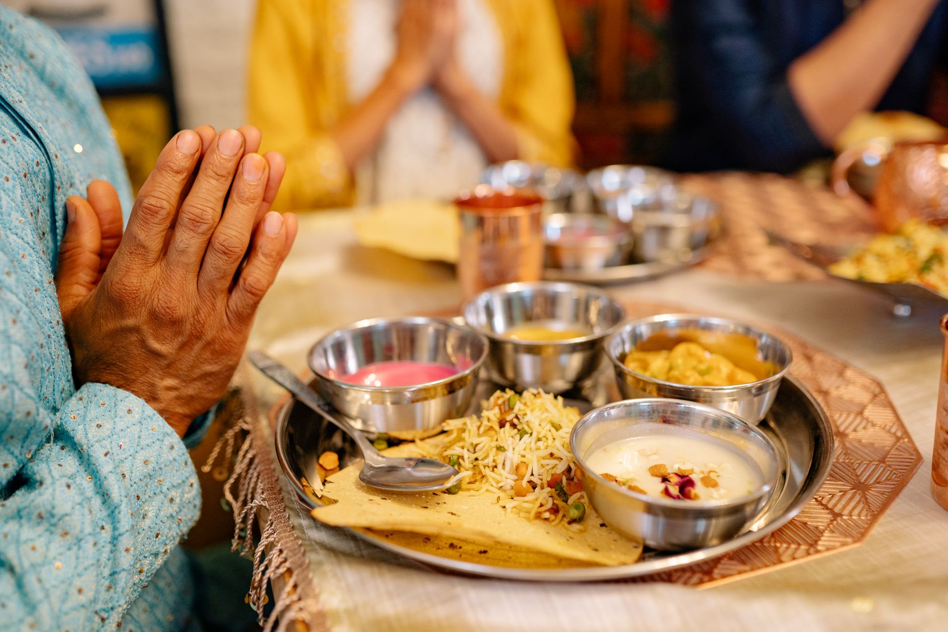 a person praying in front of the foods on the table