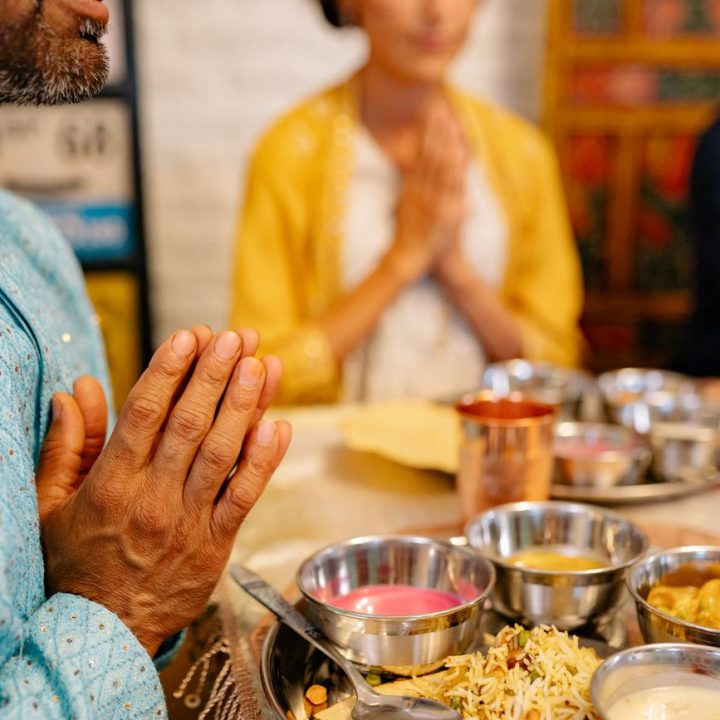 people praying over dinner