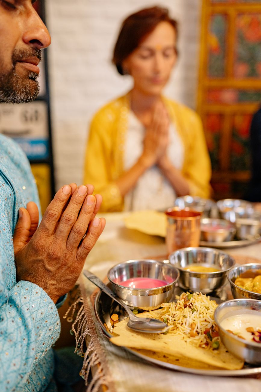 people praying over dinner
